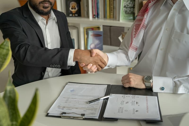 Business professionals shaking hands over a partnership agreement