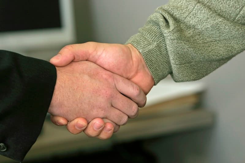 Professional handshake between mortgage lender and real estate agent